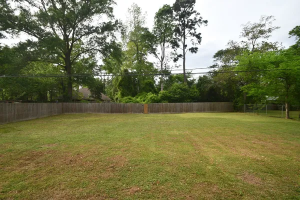 a view of a field with a trees in the background