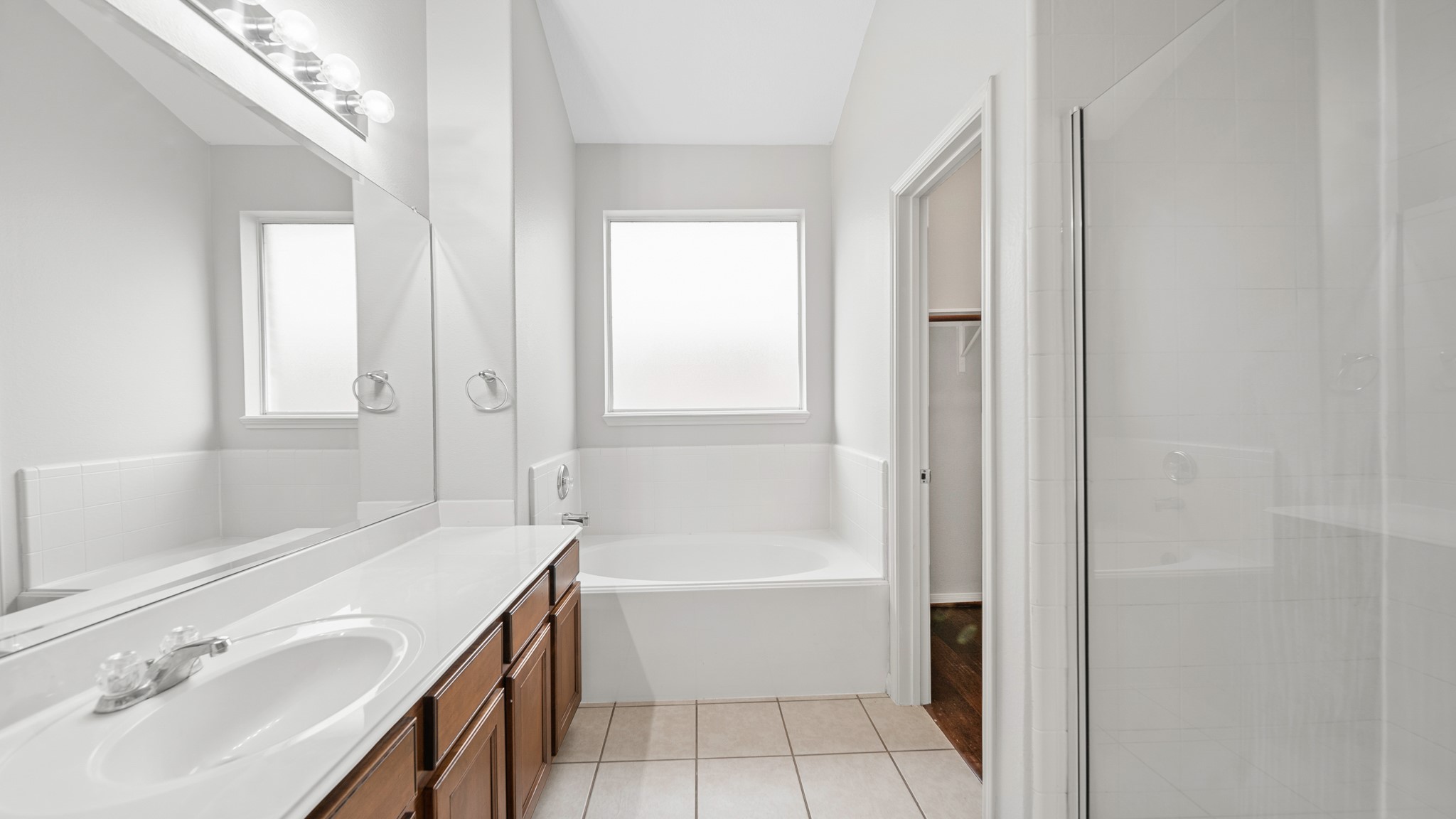 15710 Flagstone Walk Way Houston, TX 77049 - Photo 13 of 27 a bathroom with a bathtub and a sink