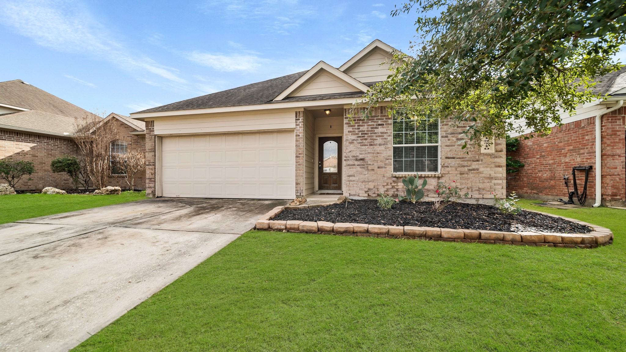 15710 Flagstone Walk Way Houston, TX 77049 - Photo 23 of 27 a front view of a house with a yard and garage