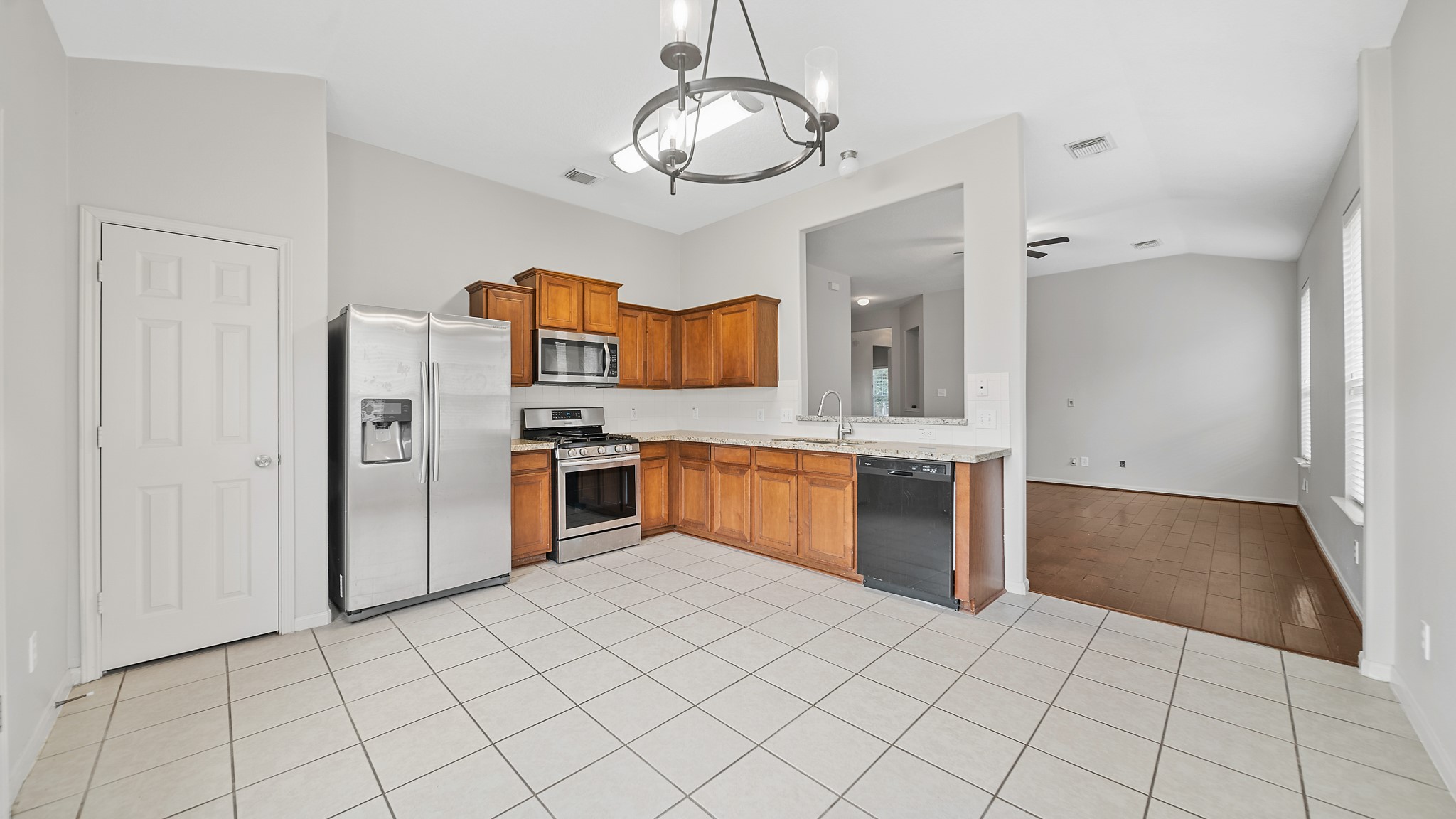 15710 Flagstone Walk Way Houston, TX 77049 - Photo 6 of 27 a kitchen with stainless steel appliances granite countertop a refrigerator and a sink
