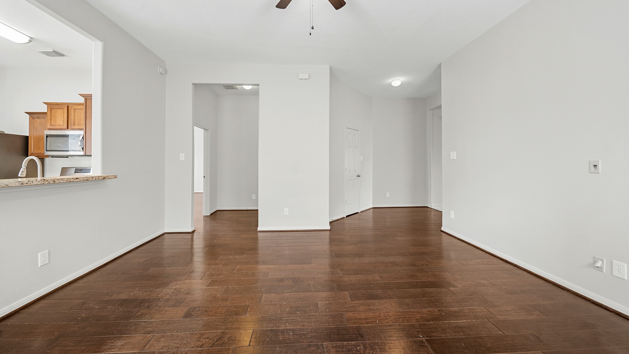 15710 Flagstone Walk Way Houston, TX 77049 - Photo 10 of 27 a view of an empty room with wooden floor and a window