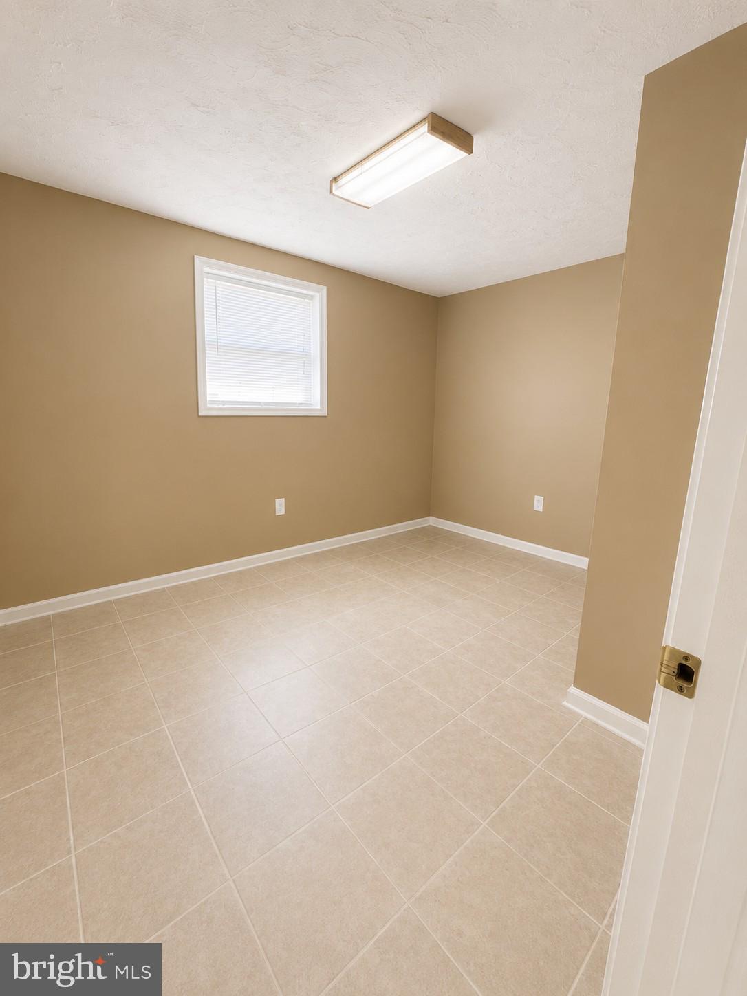 6204 Cipriano Road Lanham, MD 20706 - Photo 15 of 19 a view of an empty room with a window