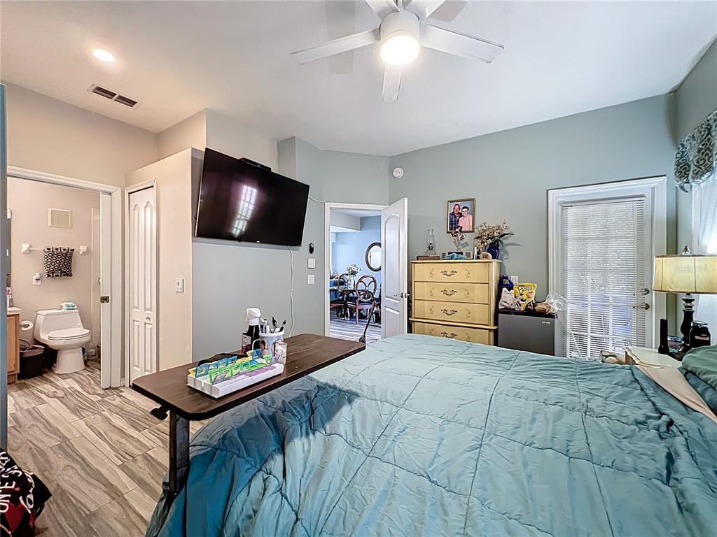 676 Sandy Neck Lane, Unit 101 Altamonte Springs, FL 32714 - Photo 14 of 24 a bedroom with a bed and a view of kitchen