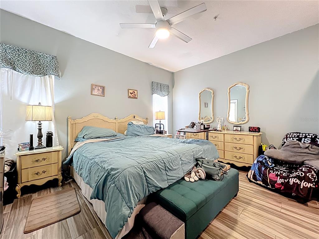 676 Sandy Neck Lane, Unit 101 Altamonte Springs, FL 32714 - Photo 15 of 24 a bedroom with a bed and a couch
