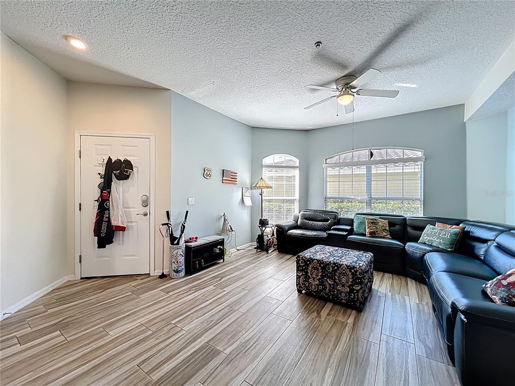 676 Sandy Neck Lane, Unit 101 Altamonte Springs, FL 32714 - Photo 2 of 24 a living room with furniture and wooden floor