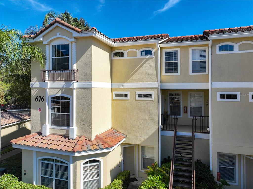 676 Sandy Neck Lane, Unit 101 Altamonte Springs, FL 32714 - Photo 22 of 24 a front view of a house with a yard
