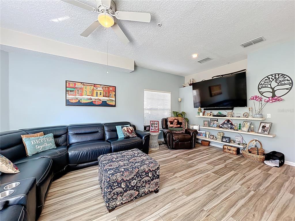676 Sandy Neck Lane, Unit 101 Altamonte Springs, FL 32714 - Photo 5 of 24 a living room with furniture and a flat screen tv