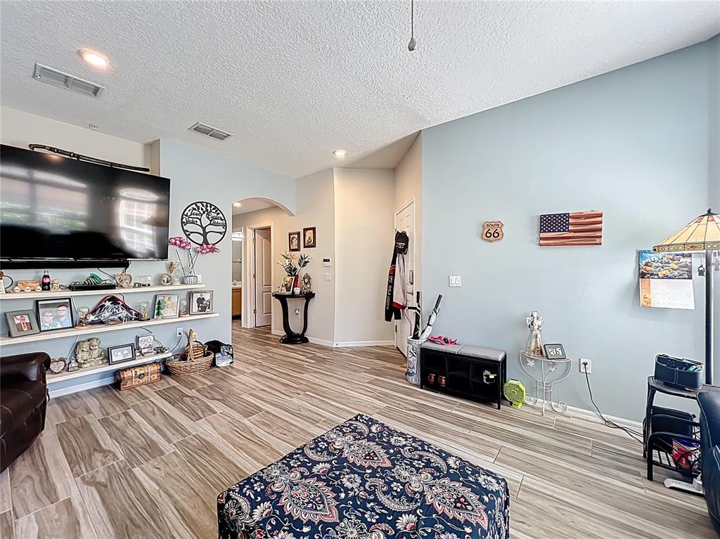 676 Sandy Neck Lane, Unit 101 Altamonte Springs, FL 32714 - Photo 6 of 24 a bedroom with furniture and a flat screen tv