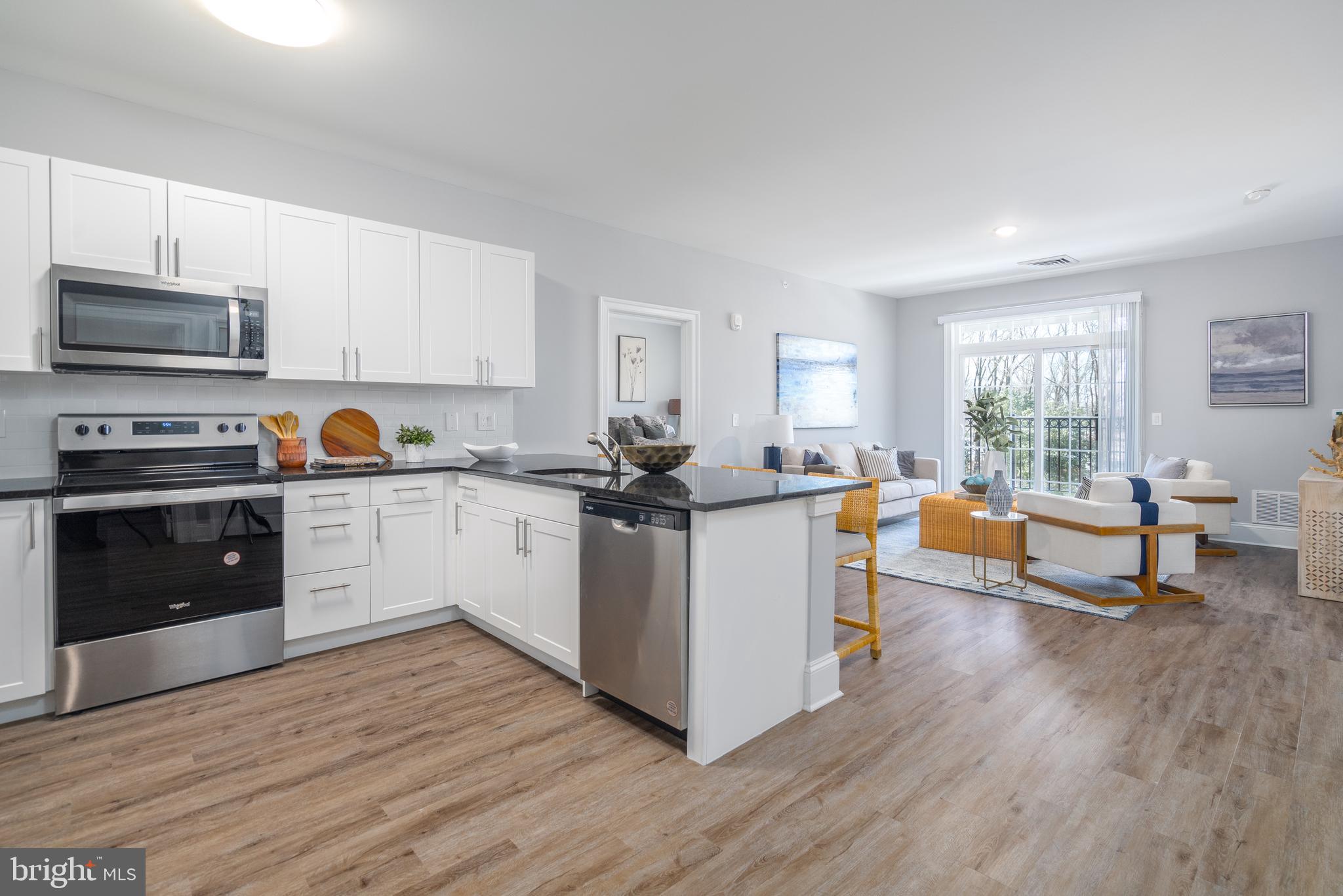 700 Citation Lane, Unit 721 Cherry Hill, NJ 08002 - Photo 1 of 1 a kitchen with wooden floors and white cabinets