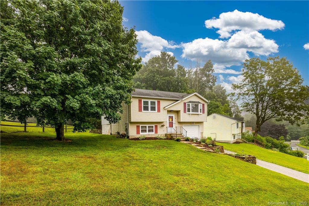 a front view of a house with a big yard