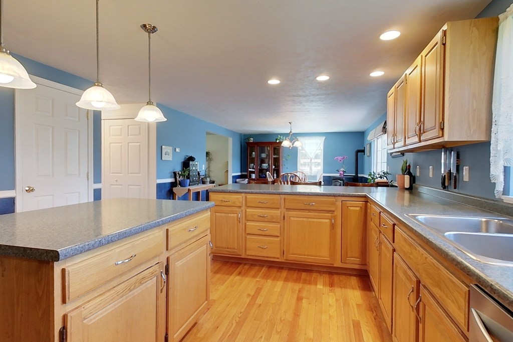 90 Benjamin Road Shirley, MA 01464 - Photo 5 of 41 a kitchen with stainless steel appliances granite countertop a sink a stove and a wooden floors