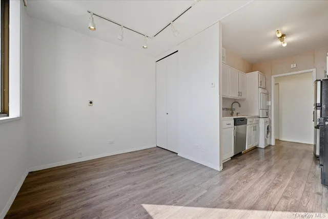 a view of kitchen with wooden floor and electronic appliances