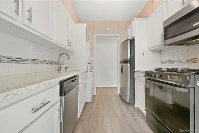 a kitchen with stainless steel appliances a sink stove and refrigerator
