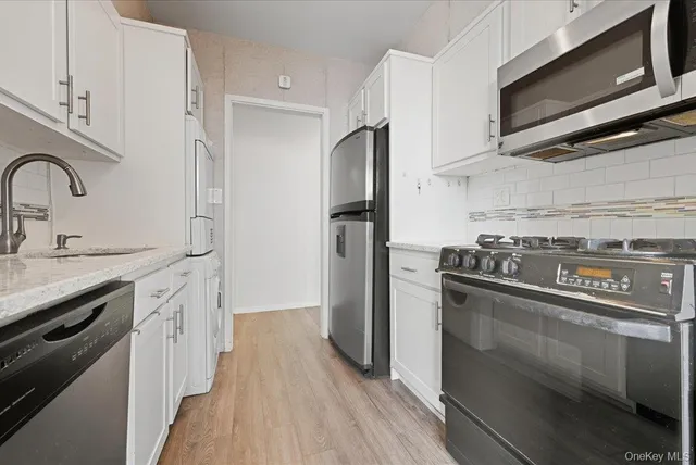 a kitchen with stainless steel appliances a sink stove and refrigerator