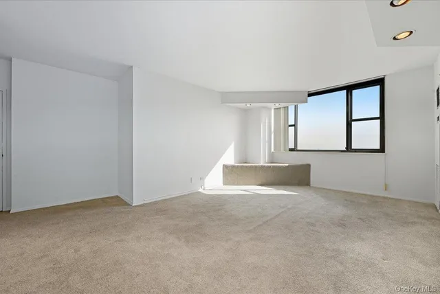 a view of an empty room with windows