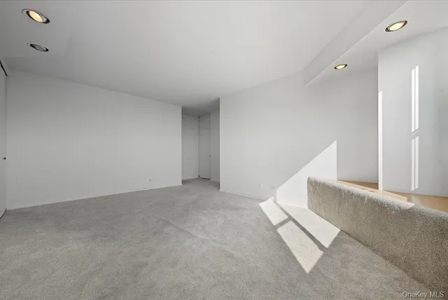 a view of an empty room with stairs