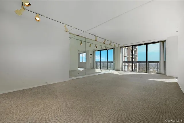a view of an empty room with a fireplace and a floor to ceiling window