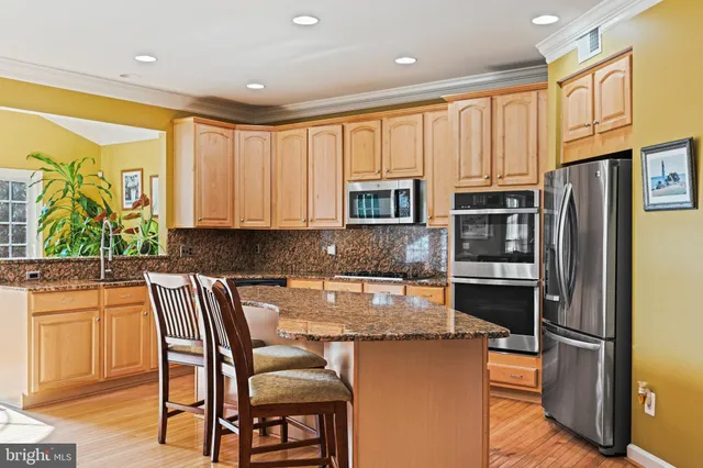 a view of a dining room with furniture a kitchen and chandelier