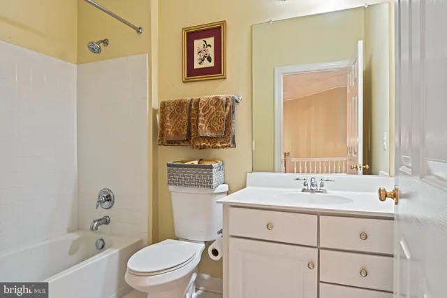 a bedroom with a bed couch and a window