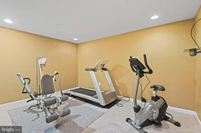 a room with gym equipment and windows