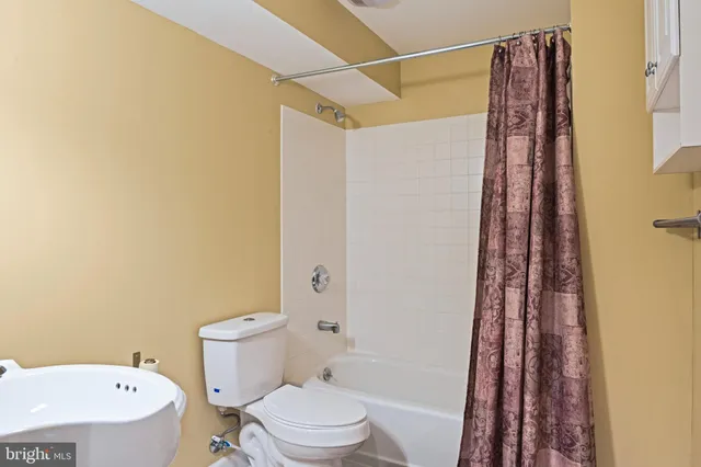 a bathroom with a toilet and a bathtub