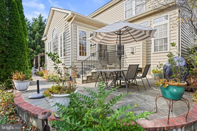 a view of a patio with table and chairs and potted plants