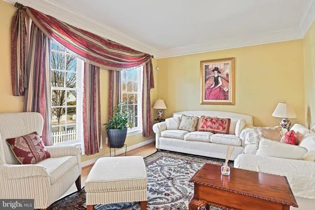 a living room with furniture and a large window with garden view