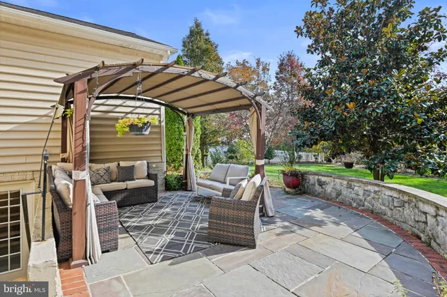 a view of backyard with outdoor seating and green space