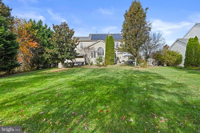 a view of a field with a house in the background