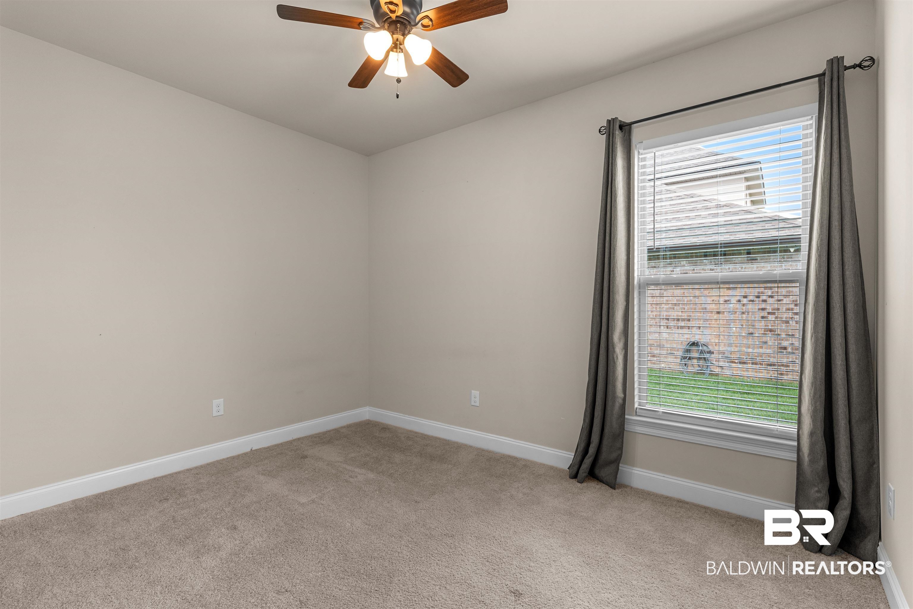 991 Dalton Circle Foley, AL 36535 - Photo 14 of 35 Spare room featuring light carpet, ceiling fan, and plenty of natural light