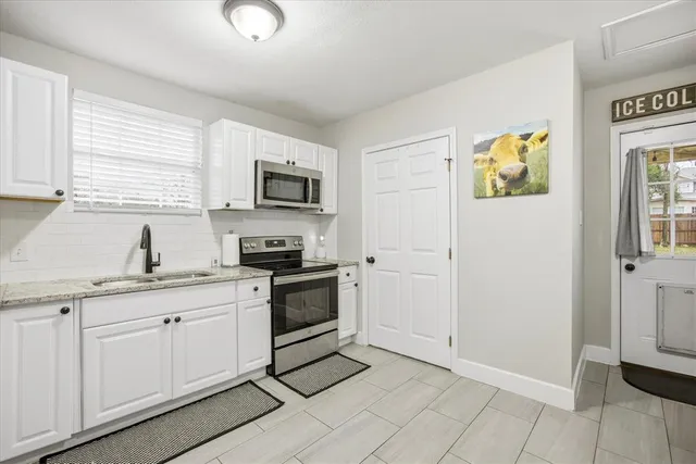 a kitchen with a sink cabinets and window