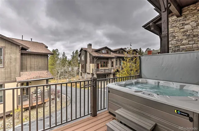 a view of a house with a balcony and wooden floor
