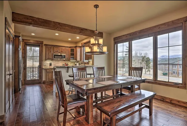 a dining room with furniture and wooden floor