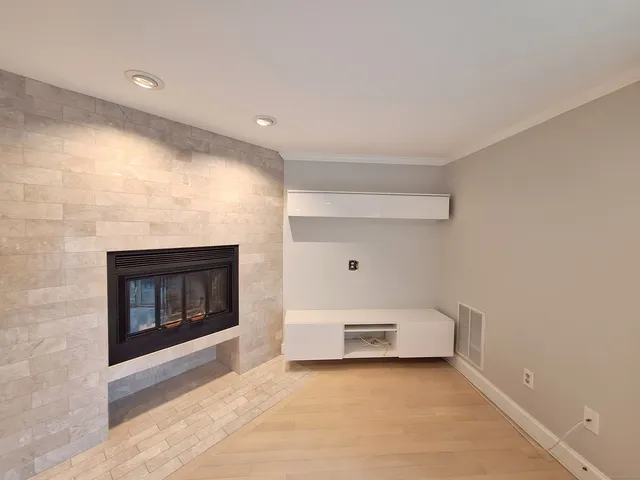 a view of empty room with a fireplace