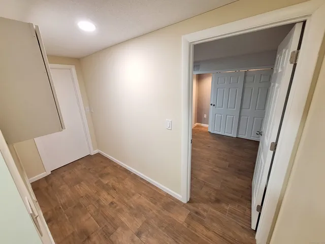 hallway with wooden floor and stairs