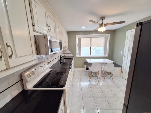 a kitchen with a sink appliances and cabinets