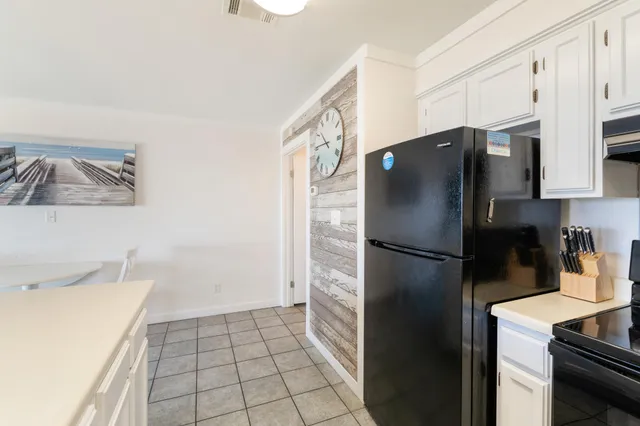 a white refrigerator freezer and a stove sitting inside of a kitchen