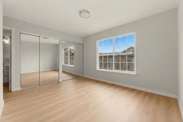 a kitchen with white cabinets and appliances