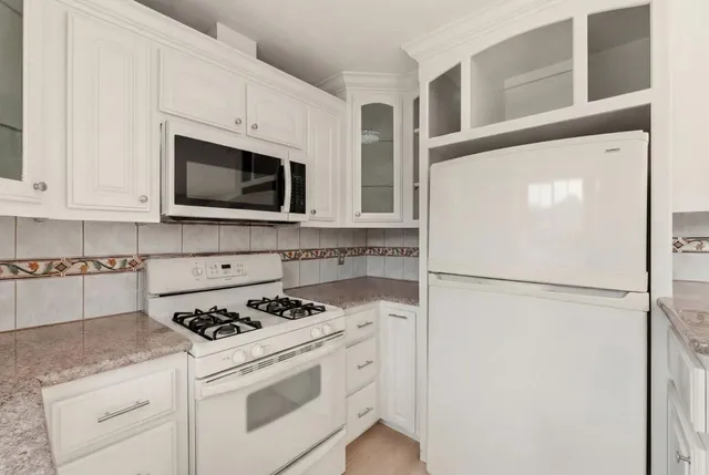 a kitchen with a sink stove and microwave