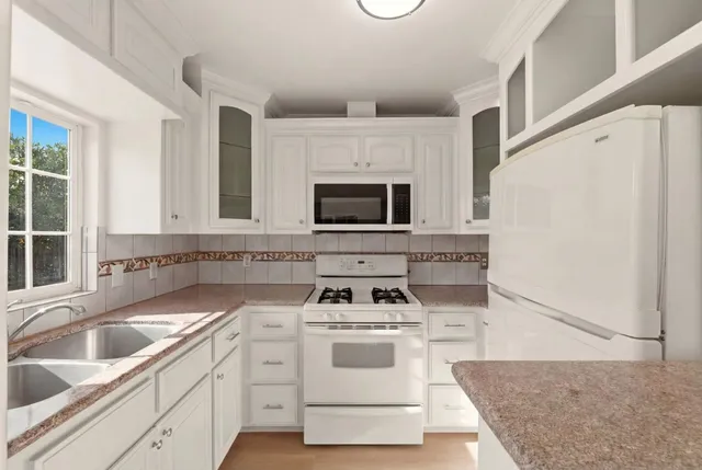 a kitchen with a sink and a refrigerator