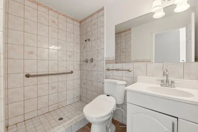 a bedroom with a bed and a potted plant