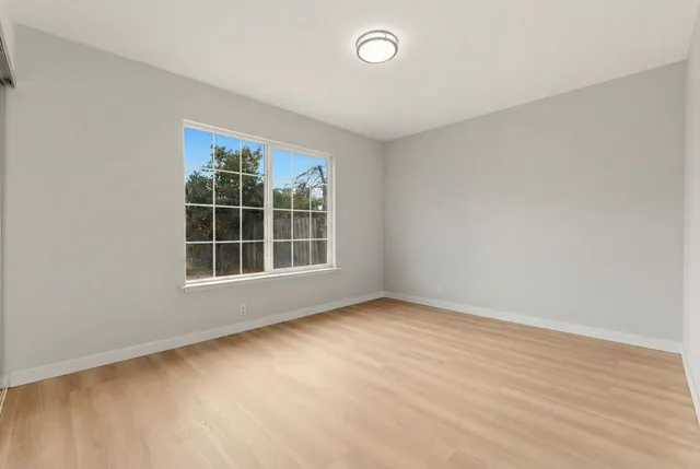 a bedroom with bed and a window