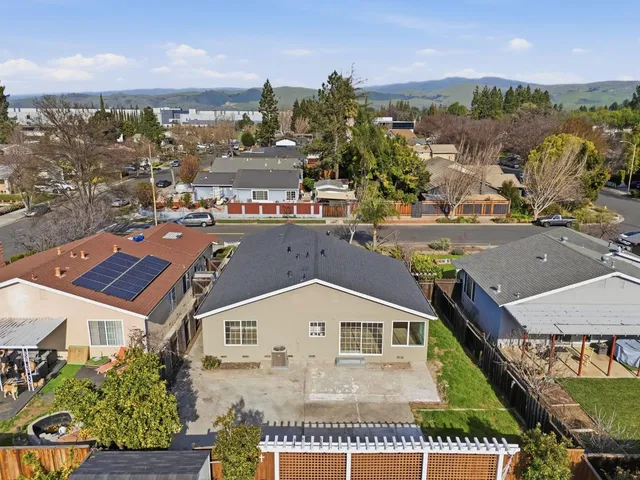 an aerial view of a residential houses with yard