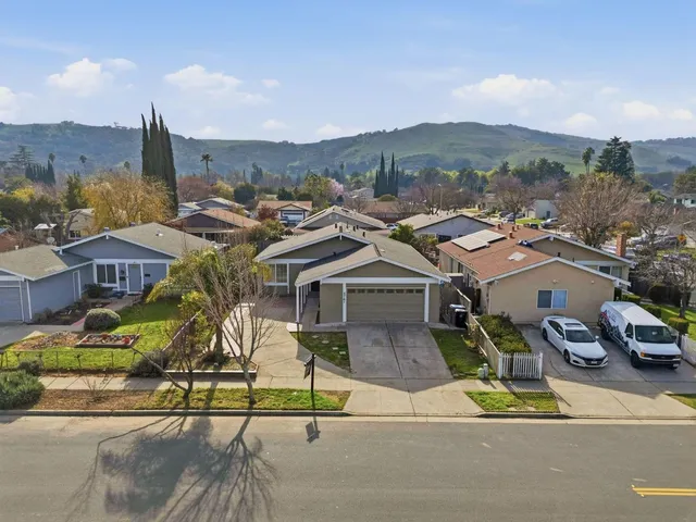 an aerial view of a house with a yard and garden