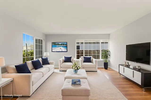 a view of empty room with wooden floor and windows