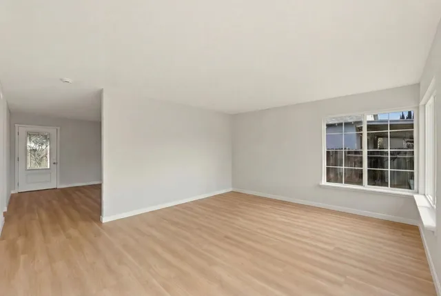 a kitchen with granite countertop white cabinets white stainless steel appliances and sink