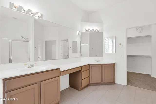 a spacious bathroom with a double vanity sink mirror and double