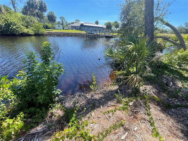 a view of a street with a building and trees in the background