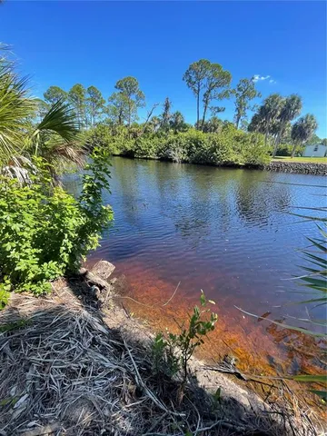 a view of a lake with houses in the back