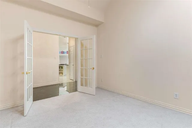 an empty room with cabinet and mirrors